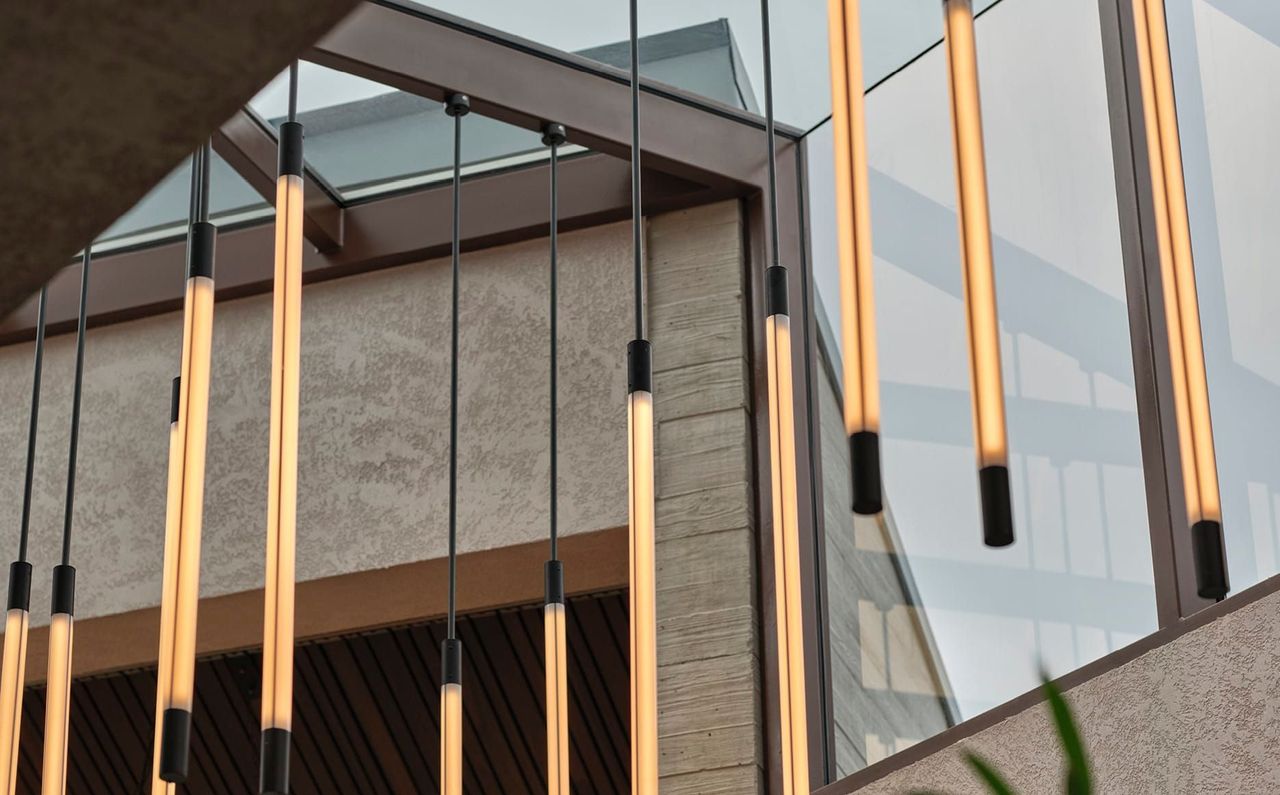 DRAMATIC CUSTOM LIGHTING DROPS FROM THE CEILING IN THE ATRIUM