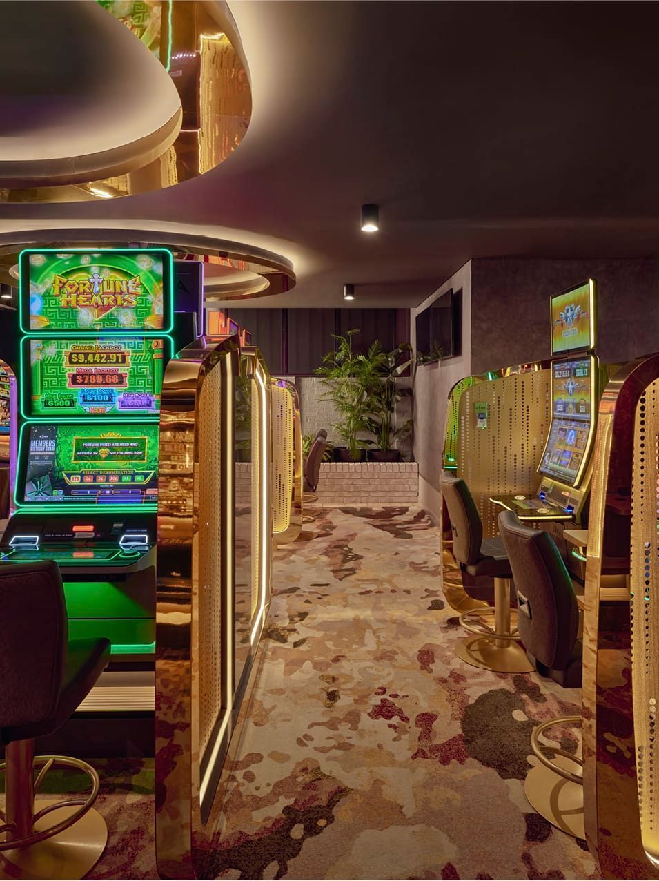 LOW BRICK WALL PROVIDES REFERENCE TO EXISTING CLUB STRUCTURE WHILE BESPOKE CARPET CONNECTS GAMING SPACES