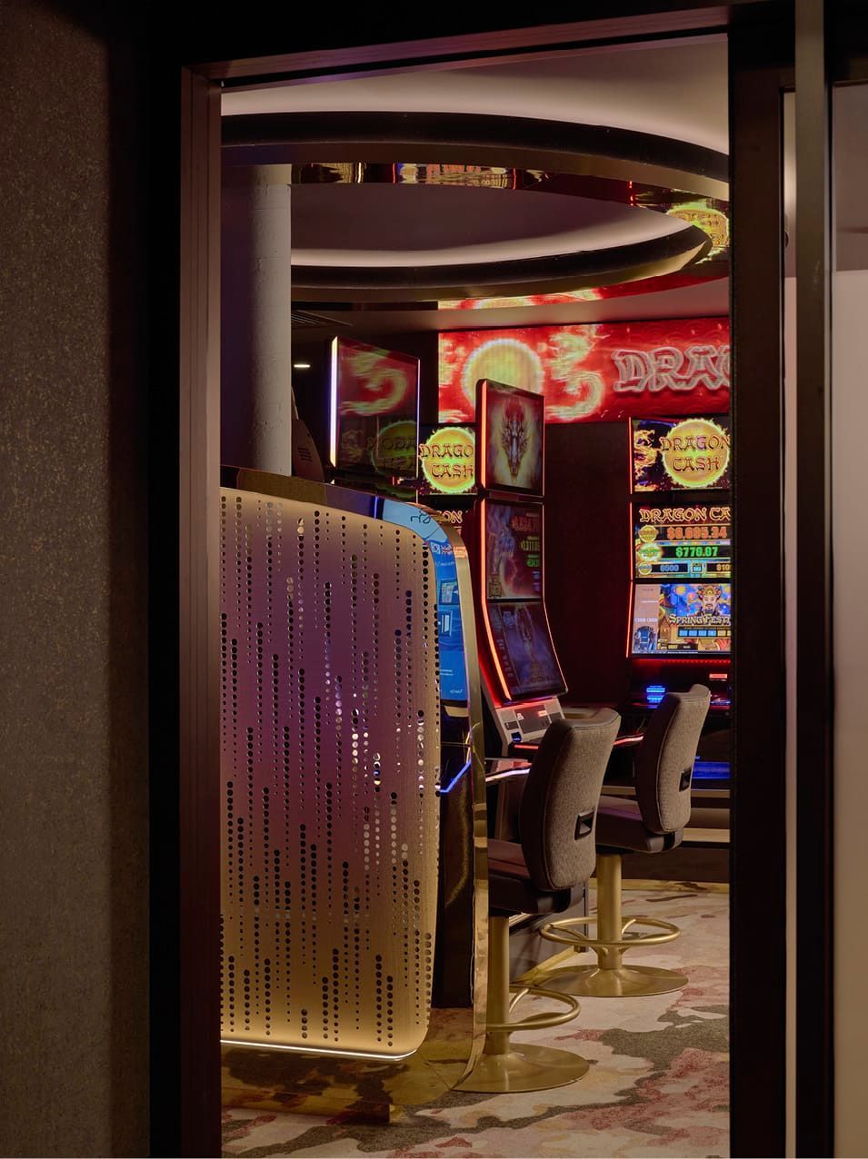 LOW BRICK WALL PROVIDES REFERENCE TO EXISTING CLUB STRUCTURE WHILE BESPOKE CARPET CONNECTS GAMING SPACES