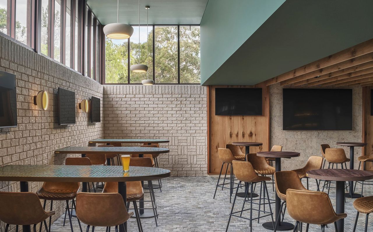 Sports lounge with large tree-lined windows