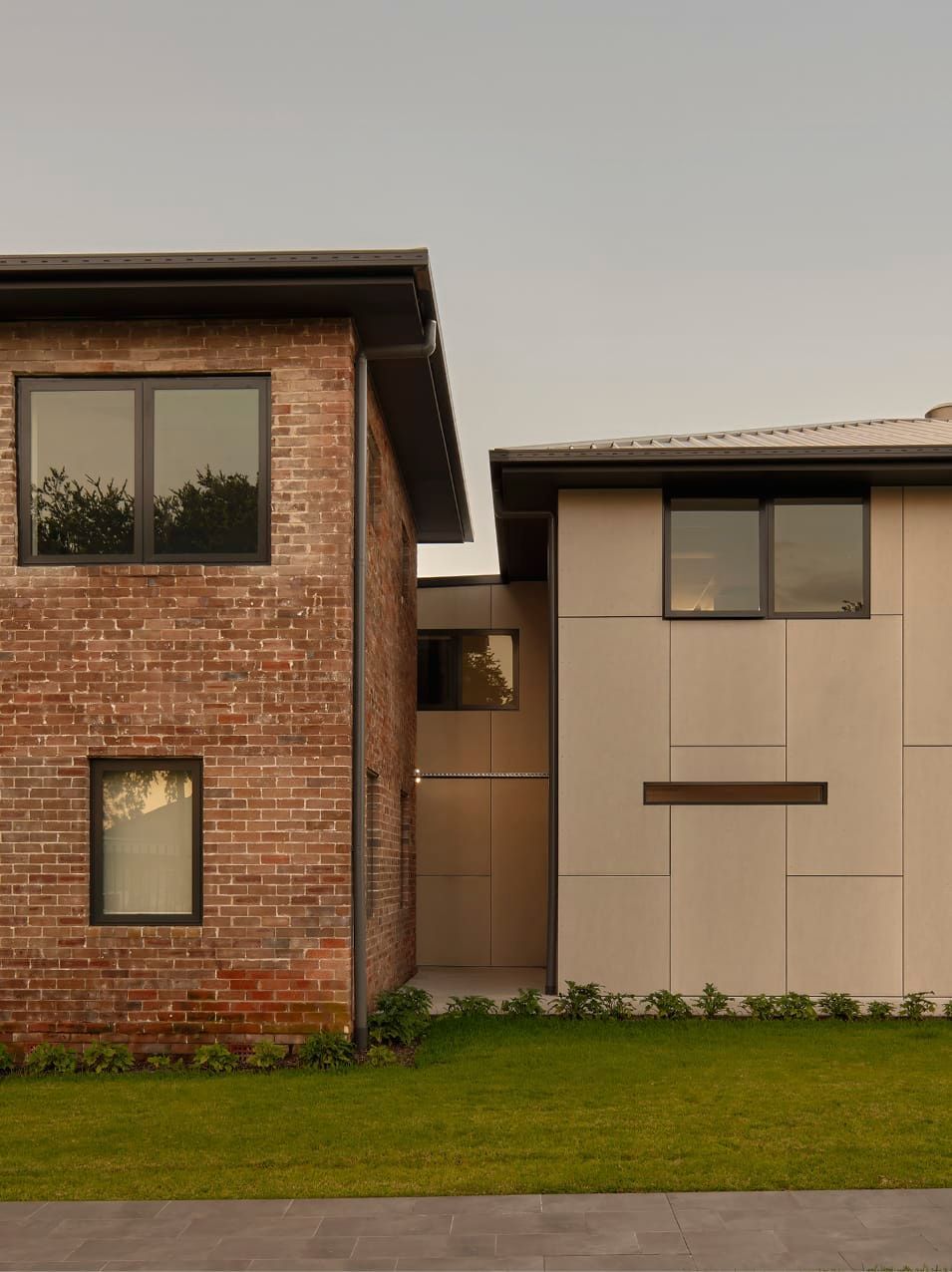ORIGINAL BRICK BUILDING REVITALISED WITH MODERN WINDOW FRAMES AND ROOF LINES