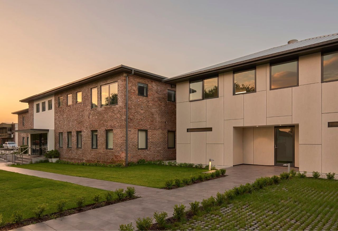 KENNY CONSTRUCTIONS FRONT FAÇADE WITH ORIGINAL BRICK BUILDING AND NEW EXTENSION