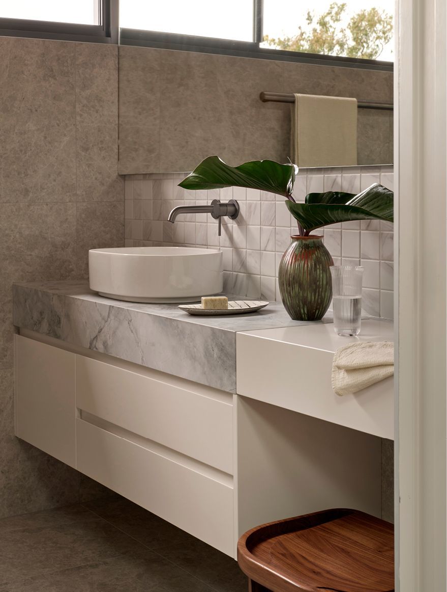 Contemporary joinery, natural stone and well-appointed hardware in the master en-suite